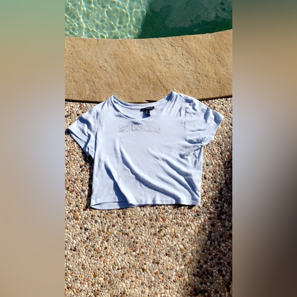 This is a forever 21 crop top. The color is baby blue and the size is a M